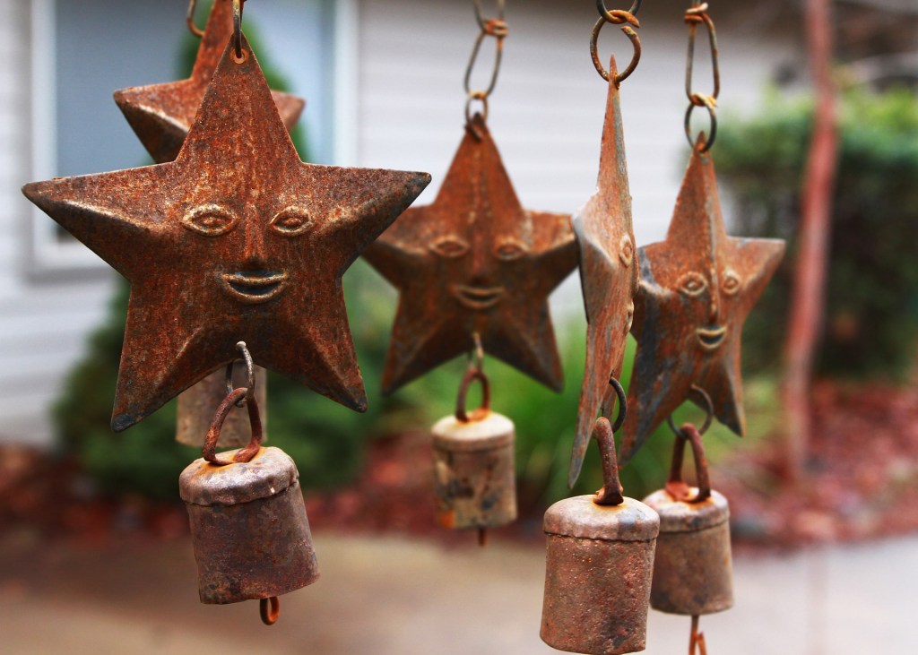 A set of wind chimes comprised of five rusty, metal stars.