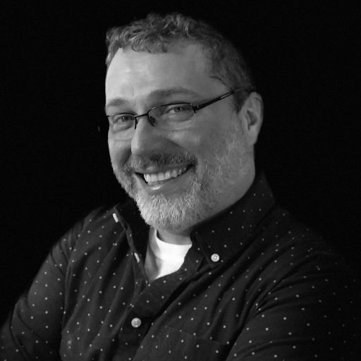 David in black and white, looking at the camera and smiling.